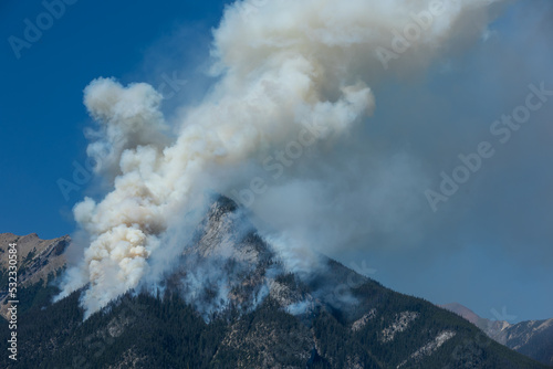 Forest wildfire and smoke on the side of a mountain © rickdeacon