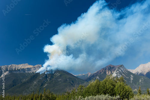 Forest wildfire and smoke on the side of a mountain