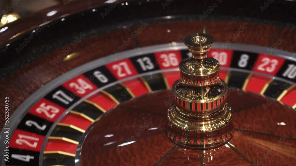 Roulette wheel in casino and ball on zero number, lose or bad luck concept, closeup view Roulette wheel in casino and ball on zero number, lose or bad luck concept, closeup view