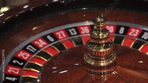 Roulette wheel in casino and ball on zero number, lose or bad luck concept, closeup view photo
