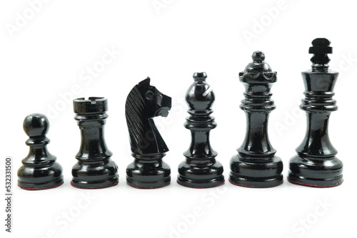 Black chess pieces made of wood in descending order isolated on white