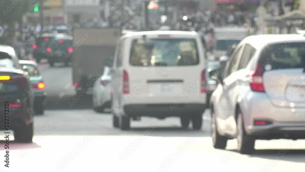 SHIBUYA, TOKYO, JAPAN : Out of focus view of street traffic around Shibuya crossing in busy rush hour. Shot in sunset time. Many cars and taxi at the road. Japanese transportation concept video.