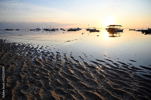 Golden Glow of Dawn Sun Silhouettes Fishing Boats, Bali Indonesia photo