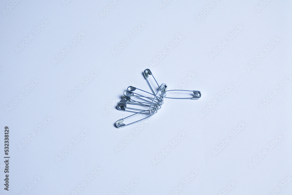 group of silver safety pins isolated in white background group of silver safety pins isolated in white background