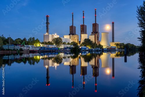 A power staion in Berlin at night with a perfect reflection in the water