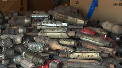TILT UP OF A PILE OF USED STOLEN CATALYTIC CONVERTERS