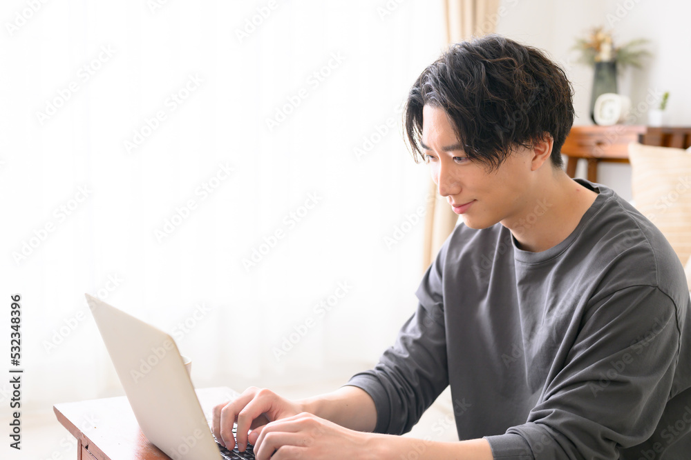 Handsome man at computer, backlit, profile Handsome man at computer, backlit, profile