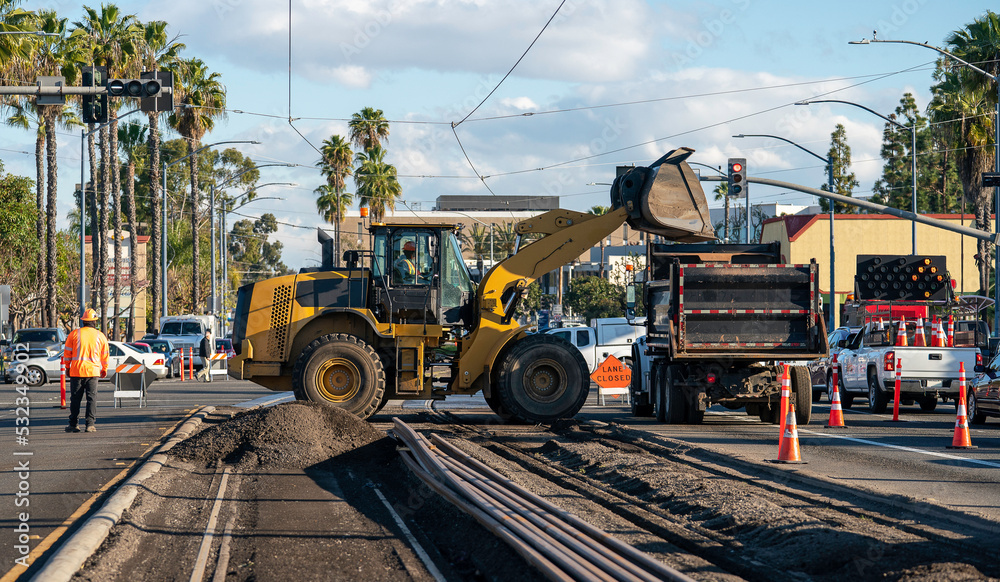 railroad track construction site transit street car site with bulldozer and dump truck railroad track construction site transit street car site with bulldozer and dump truck