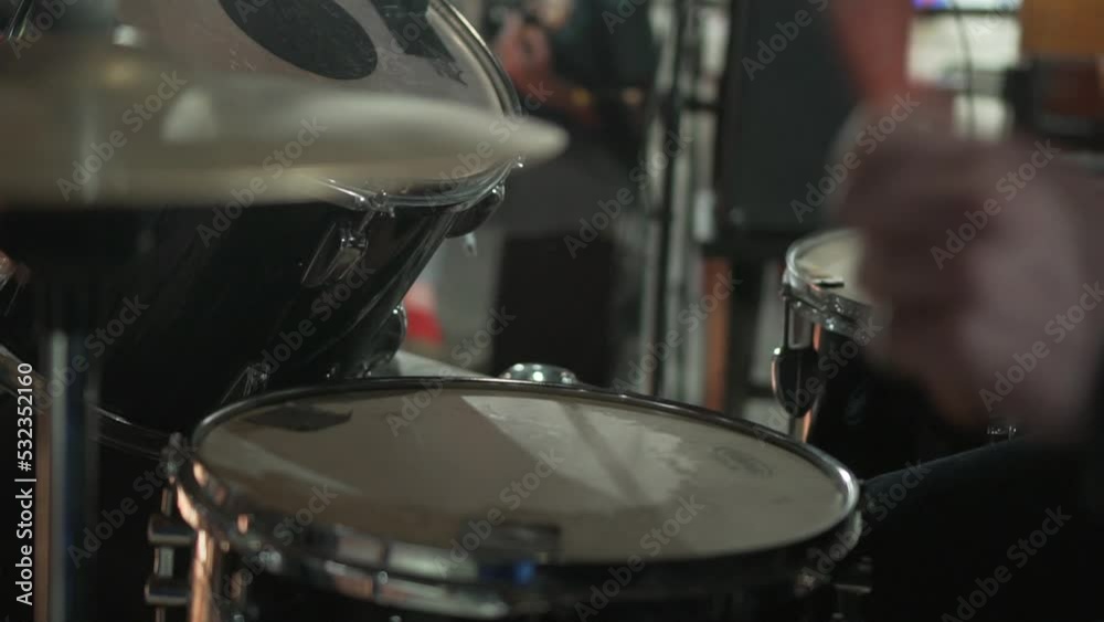 Close up shot of two drum sticks hitting a cymbal. The drum stick hit on the crash cymbal. Live rock show in club Close up shot of two drum sticks hitting a cymbal. The drum stick hit on the crash cymbal. Live rock show in club