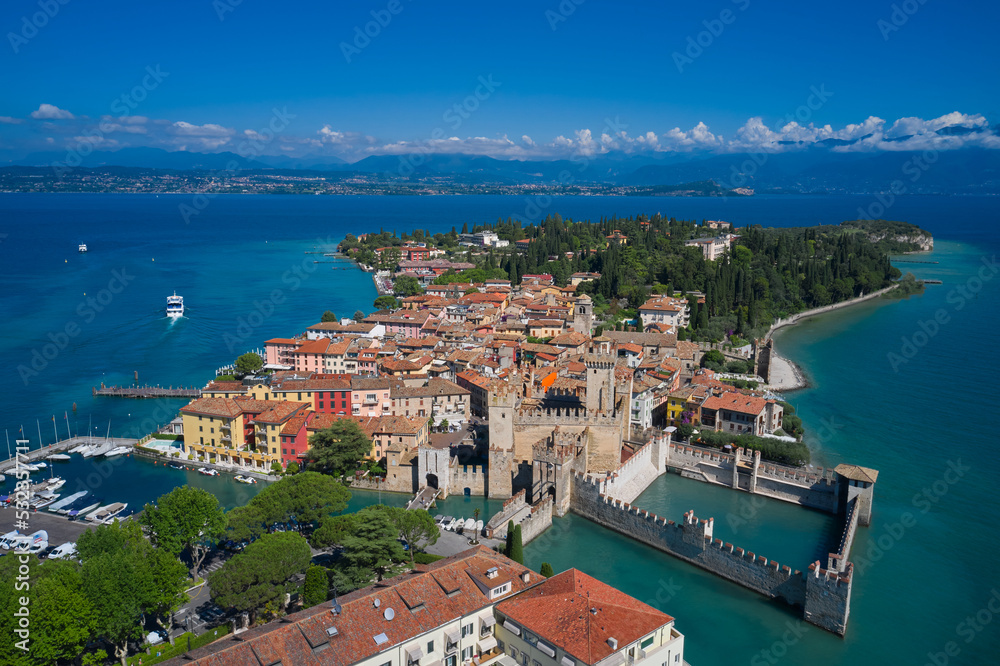 Aerial photography with drone. Aerial view on Sirmione sul Garda. Italy, Lombardy.  Rocca Scaligera Castle in Sirmione. View of the Italian town of Sirmione and Lake Garda