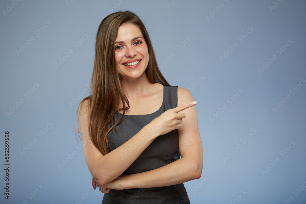 Obraz premium Smiling business woman pointing with finger side away at copy space. isolated portrait.