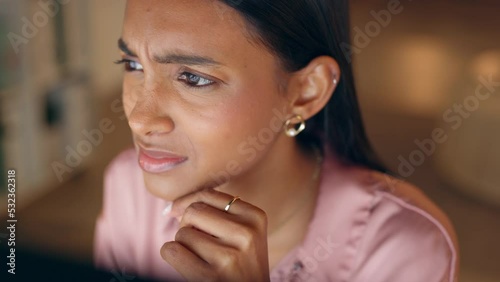 Stress, anxiety and business woman looking confused while working late on a computer in a corporate office. Glitch, error and indian entrepreneur missing deadline, unhappy and worried about workload photo