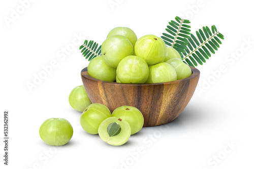 Slika na platnu Indian gooseberry fruits or Amla (phyllanthus emblica) in wooden bowl with green leaf isolated on white background