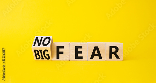 No fear vs big fear symbol. Turned wooden cubes withs words Big fear and No Fear. Beautiful yellow background. Business concept. Copy space. photo