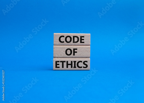 Code of ethics symbol. Concept words Code of ethics on wooden blocks. Beautiful blue background. Business and Code of ethics concept. Copy space.