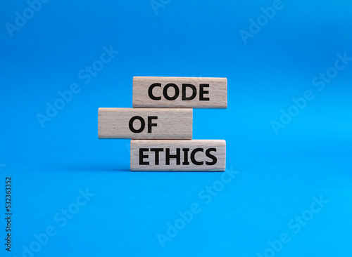 Code of ethics symbol. Concept words Code of ethics on wooden blocks. Beautiful blue background. Business and Code of ethics concept. Copy space.