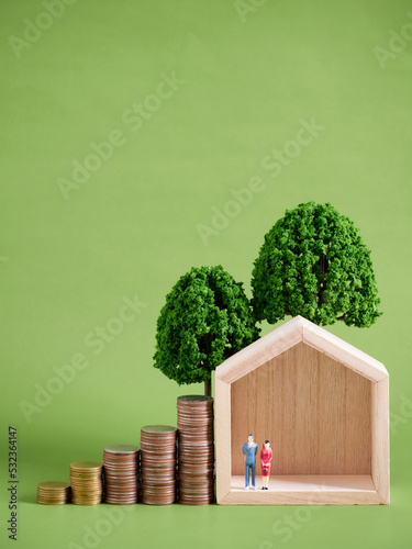 Miniature house model with coins stacks