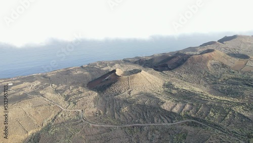aerial shot on a sunny day where you can see volcanoes near the viewpoint of La Peña and Roque de Salmor. On the island of El Hierro. photo