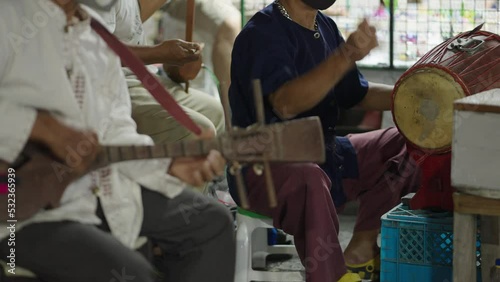 A static shot of a band where band members are seen playing different instruments to entertain people 