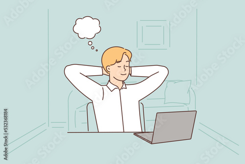 Young woman distracted from computer work dreaming 