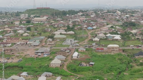 AERIAL - Cityscape in Jos Plateau, Nigeria, truck left reveal photo