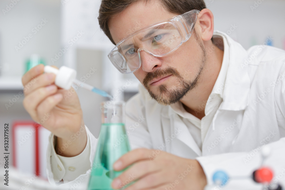 researcher at work in a laboratory with a blood pipette - obrazy, fototapety, plakaty 