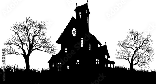 A silhouette haunted Halloween house with spooky trees photo