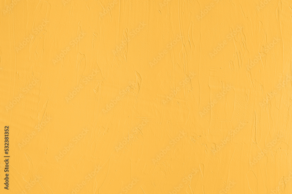 Saturated pastel yellow colored low contrast Concrete textured background. Empty colourful wall texture with copy space for text overlay and mockups. 2023, 2024 color trend