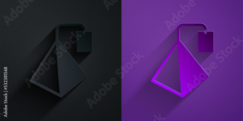 Paper cut Tea bag icon isolated on black on purple background. Paper art style. Vector