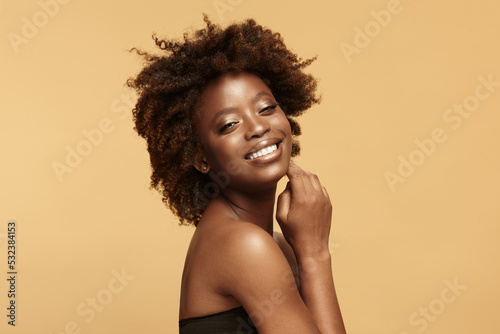 Attractive black woman with tilted head laughing.