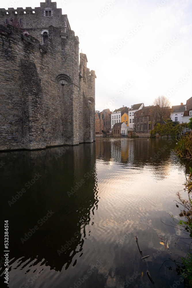 Obraz premium Gravensteen , medieval castle near leie river in old town of ghent dunring winter evening : Ghent , Belgium : November 30 , 2019