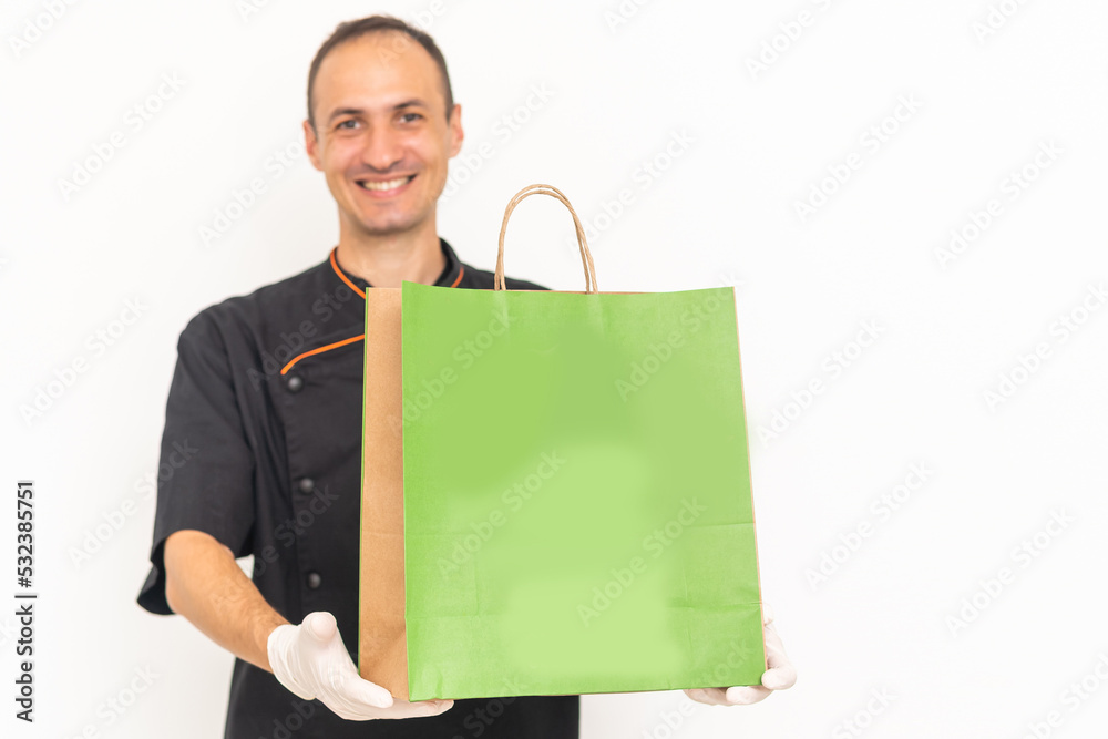 Food delivery in the restaurant. The chef packs food Food delivery in the restaurant. The chef packs food