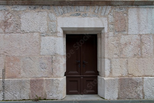 Fototapeta Naklejka Na Ścianę i Meble -  Closeup stone wall historic facade door background