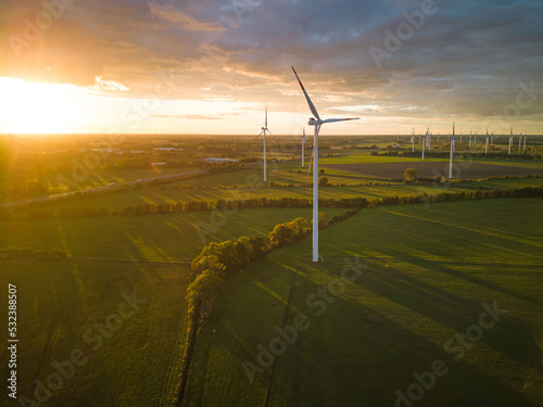 Aerial View of Windturbine against sunset with moody golden lighting