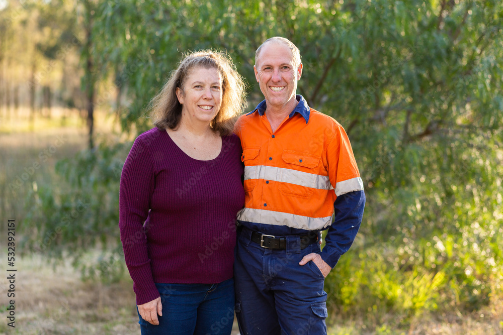 Portrait of a happy middle aged couple with man in high-vis workwear Portrait of a happy middle aged couple with man in high-vis workwear