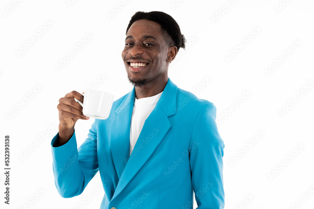 Happy dark skinned buisnessman looking at camer smiling in good mood standing on white background in studio holding cup of cofee in hand wearing beautiful elegant casual blue suit. Happy dark skinned buisnessman looking at camer smiling in good mood standing on white background in studio holding cup of cofee in hand wearing beautiful elegant casual blue suit.