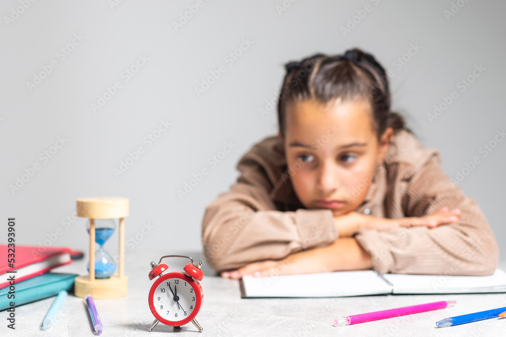 Little cute girl is bored and tired with doing her homework Little cute girl is bored and tired with doing her homework