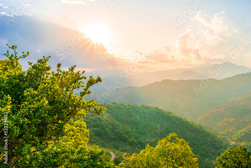 Mountain valley during sunset or sunrise. Natural spring or summer season landscape