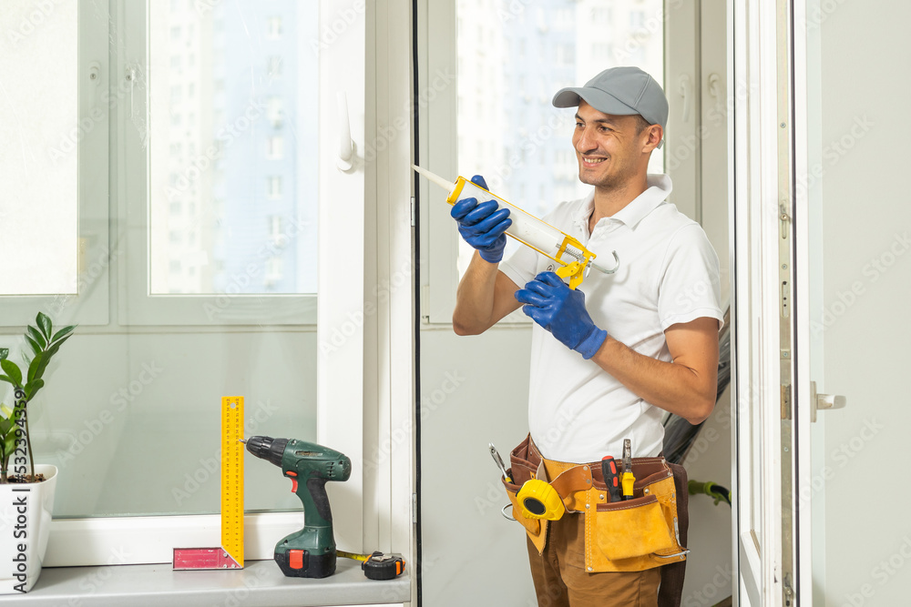 master puts a new double-glazed window in a plastic window master puts a new double-glazed window in a plastic window