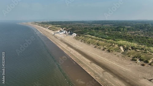 Establishing Aerial Drone Shot of Dunes Around Rockanje, Netherlands on a Beautiful Sunny Day photo