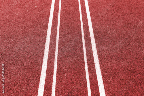 Red field rubber ground with white lines. Outdoor © kelifamily