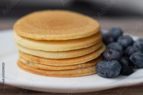 Rice flour and coconut milk pancakes with blueberries. Macro photo, selective focus.