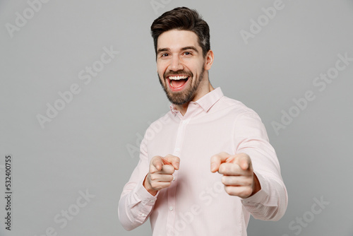 Young confident leader caucasian man 20s he wears basic white shirt point index finger camera on you motivating encourage isolated on plain grey background studio portrait. People lifestyle concept.