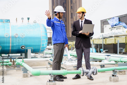 Professional Asian foreman and construction manager talking - discussing about building structure plant together.