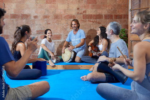 Group of people singing and playing instruments, having a good time