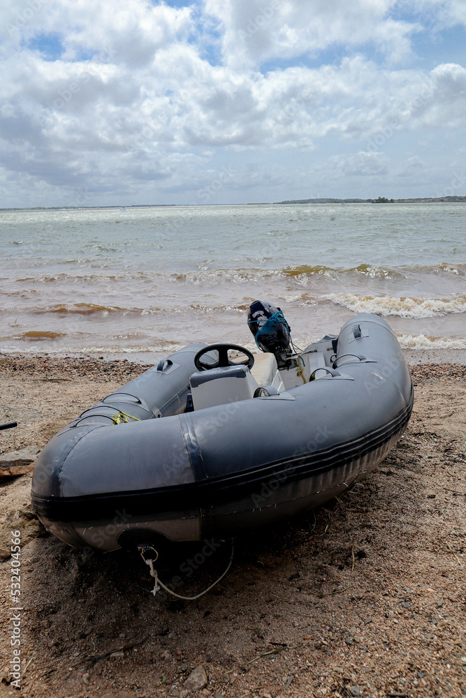 An Inflatable Motorboat is seen docked on a river bank against the overcast clouds near Mysuru in Karnataka, India.
An Inflatable Motorboat is seen docked on a river bank against the overcast clouds near Mysuru in Karnataka, India.