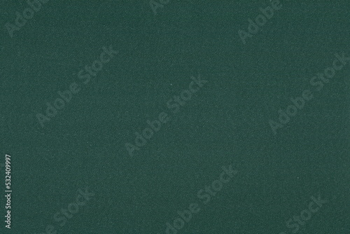 The texture of a coarse, dense dark green heavy fabric. Background of coarse natural fabric.