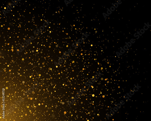 Golden confetti and glitter texture on a black background.