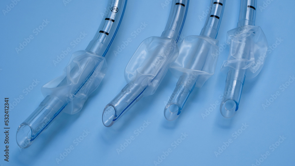 endotracheal tubes of different sizes and diameters lie on a light blue background endotracheal tubes of different sizes and diameters lie on a light blue background