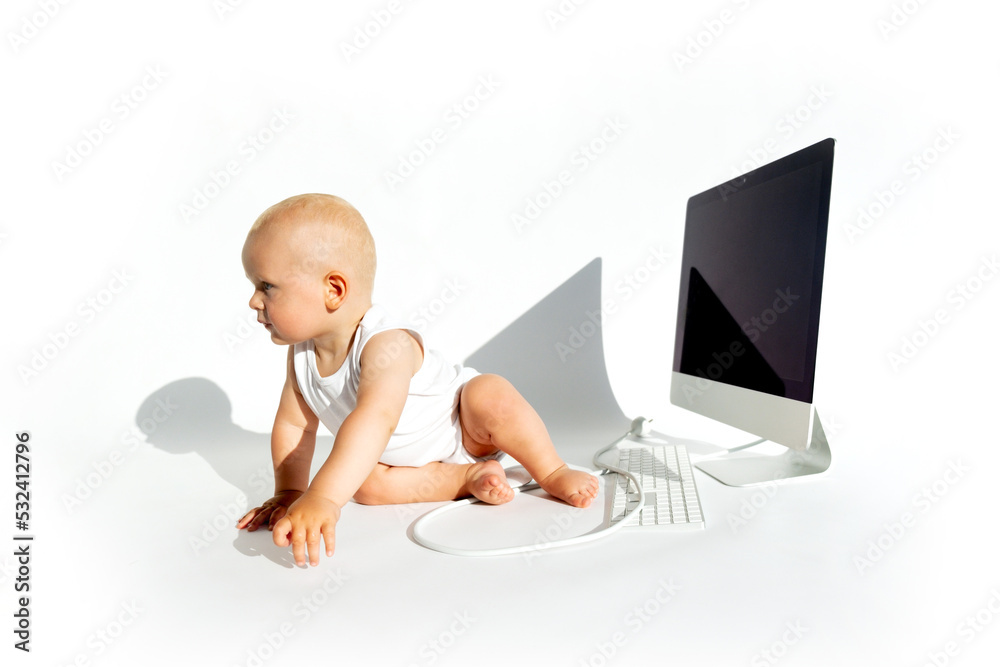 Cute baby playing with laptop computer isolated on white background. Copy space. Early childhood education concept. Children cartoon addiction Cute baby playing with laptop computer isolated on white background. Copy space. Early childhood education concept. Children cartoon addiction